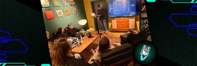 Foto vom AI Meetup im Dezember 2025 in Bochum, bei dem die Gäste nach vorne schauen. Dort hält ein Teilnehmer eine Rede, bei der er auf seinen Laptop guckt. Hinter ihm ist seine Präsentation auf einem Bildschirm zu sehen.